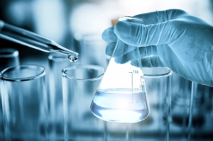 A person collecting a well water sample for testing.